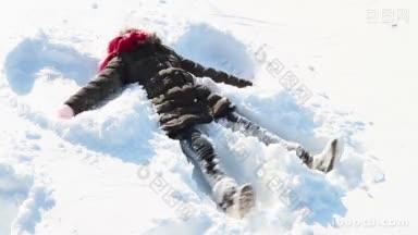 小女孩在雪地里做天使